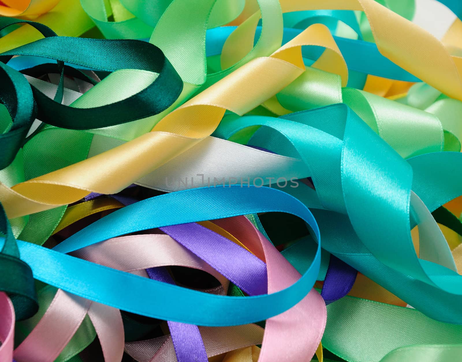 Multi-colored satin ribbons in a chaotic manner closeup

