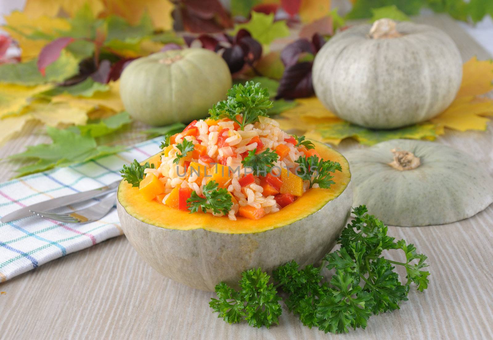 porridge of rice and vegetables with pumpkin in the pumpkin and greens