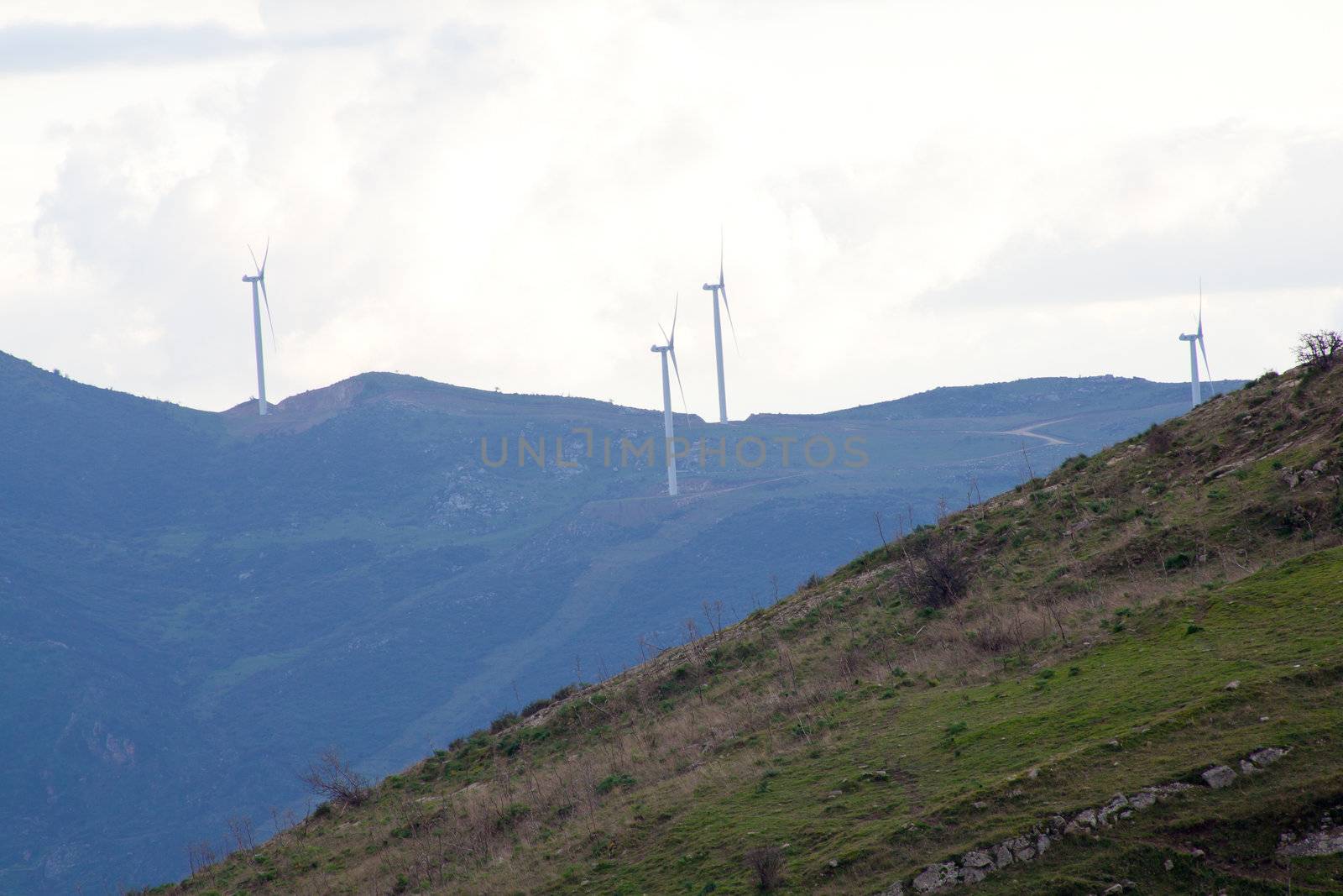 View of Wind turbines in the mountain with clouds