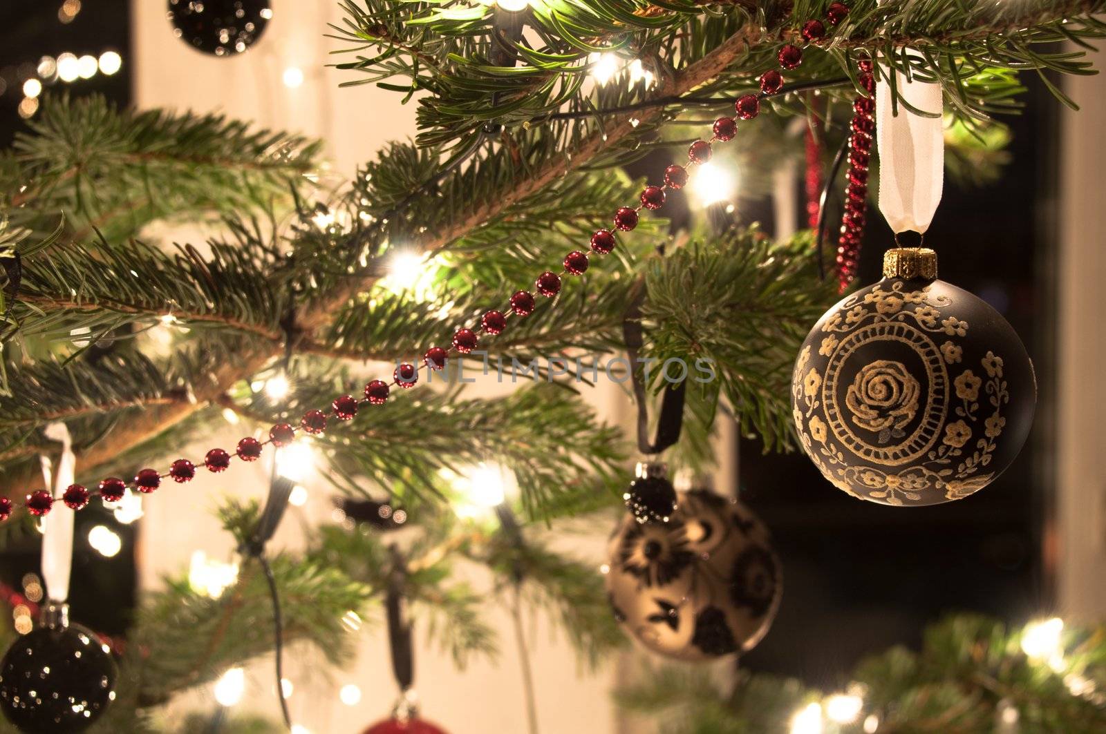 Decorative christmas balls and decoration hanging on pine - tree branch