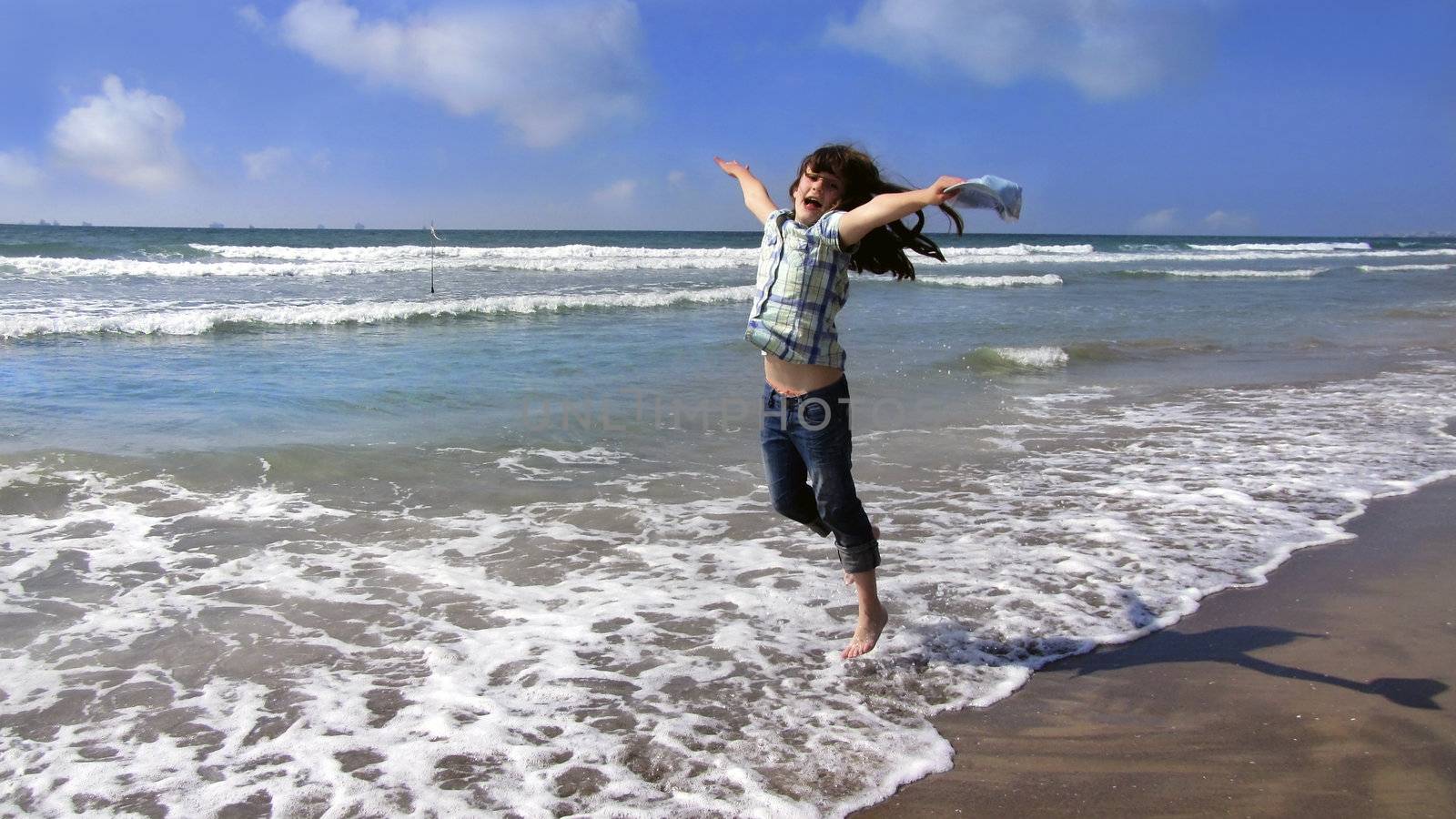girl jumping on the waves.beautiful sea and sunny weather