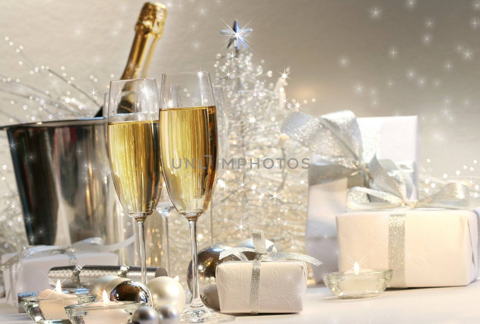 Champagne glasses with silver shimmering lit background