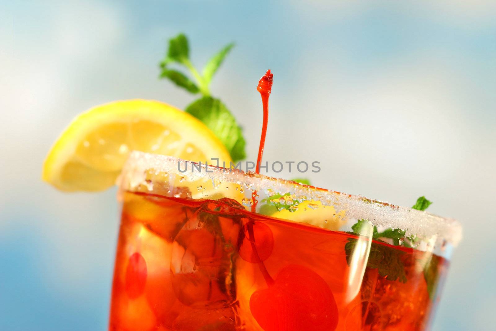 Closeup of tropical drink against blue sky