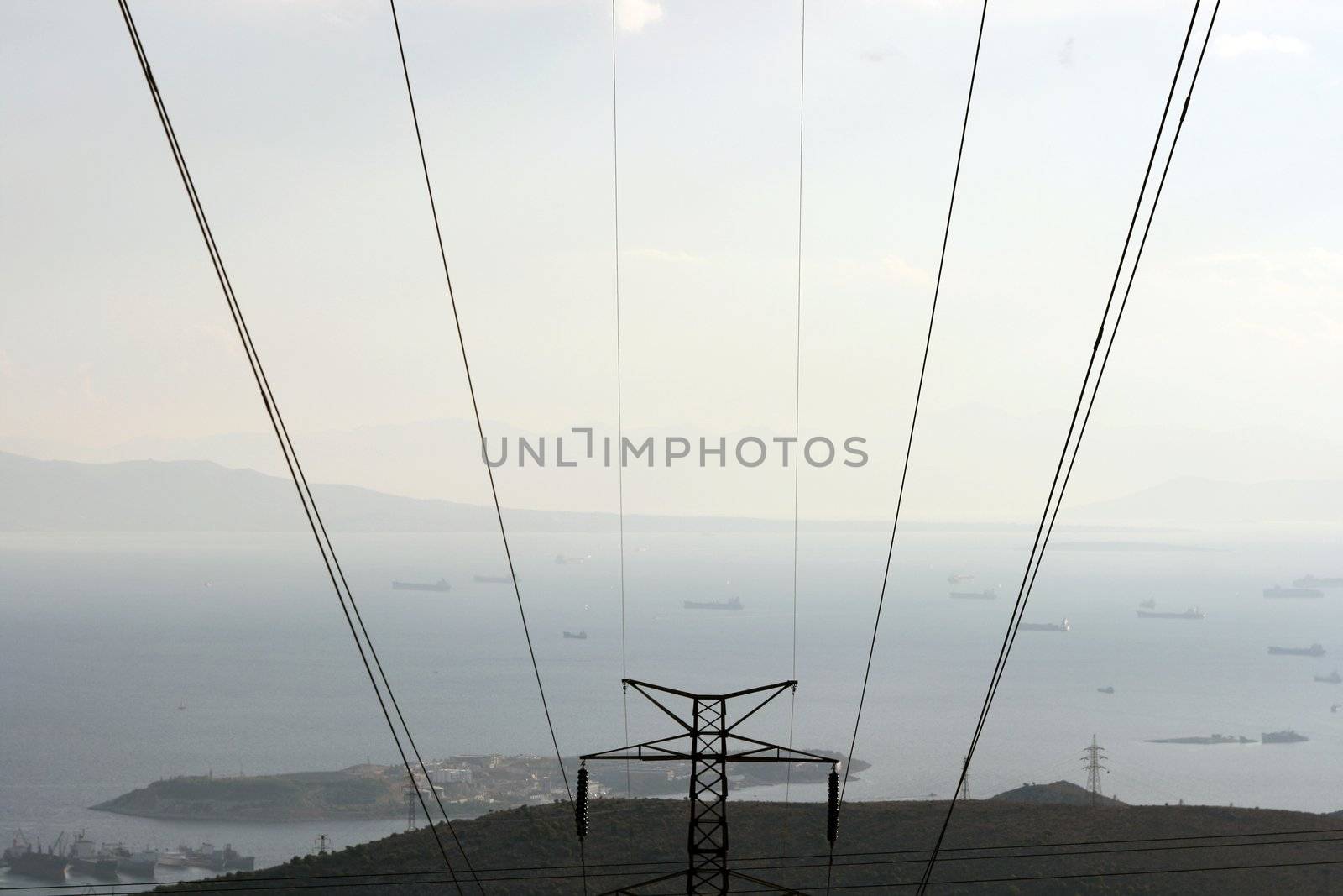 prespective dark electric cables and view of sea and ships in the afternoon at piraeus greece