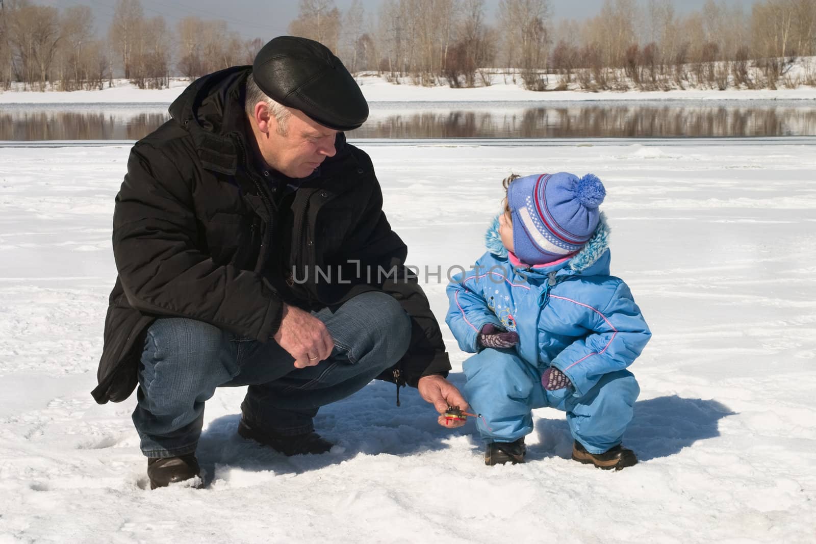 The boy, the child with the father on on winter fishing