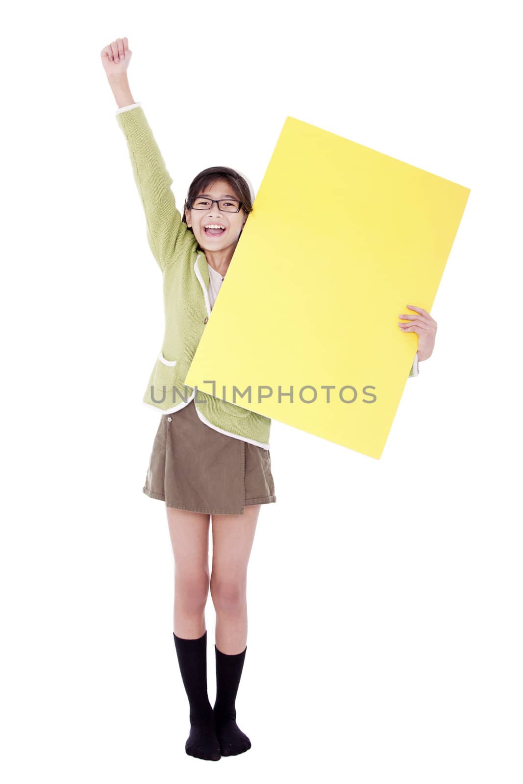 Biracial asian girl in green sweater holidng blank yellow sign, arm cheering in air