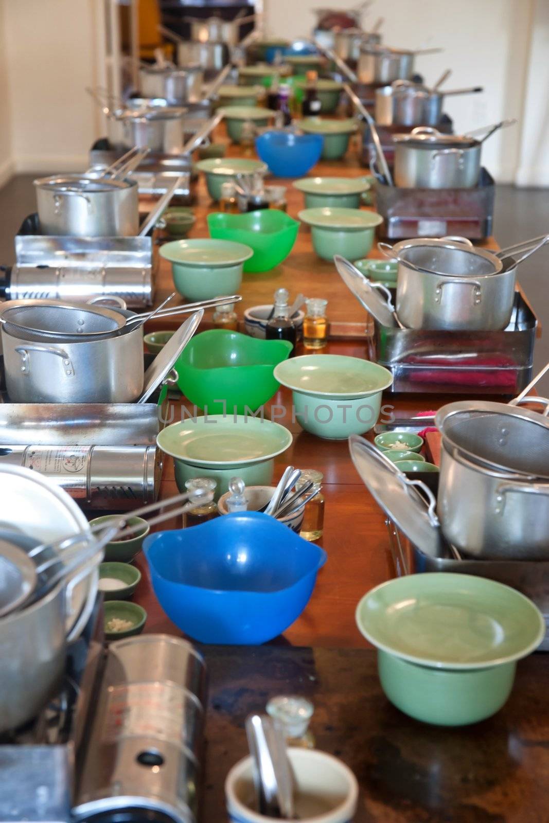 cookware and utensils on a long table