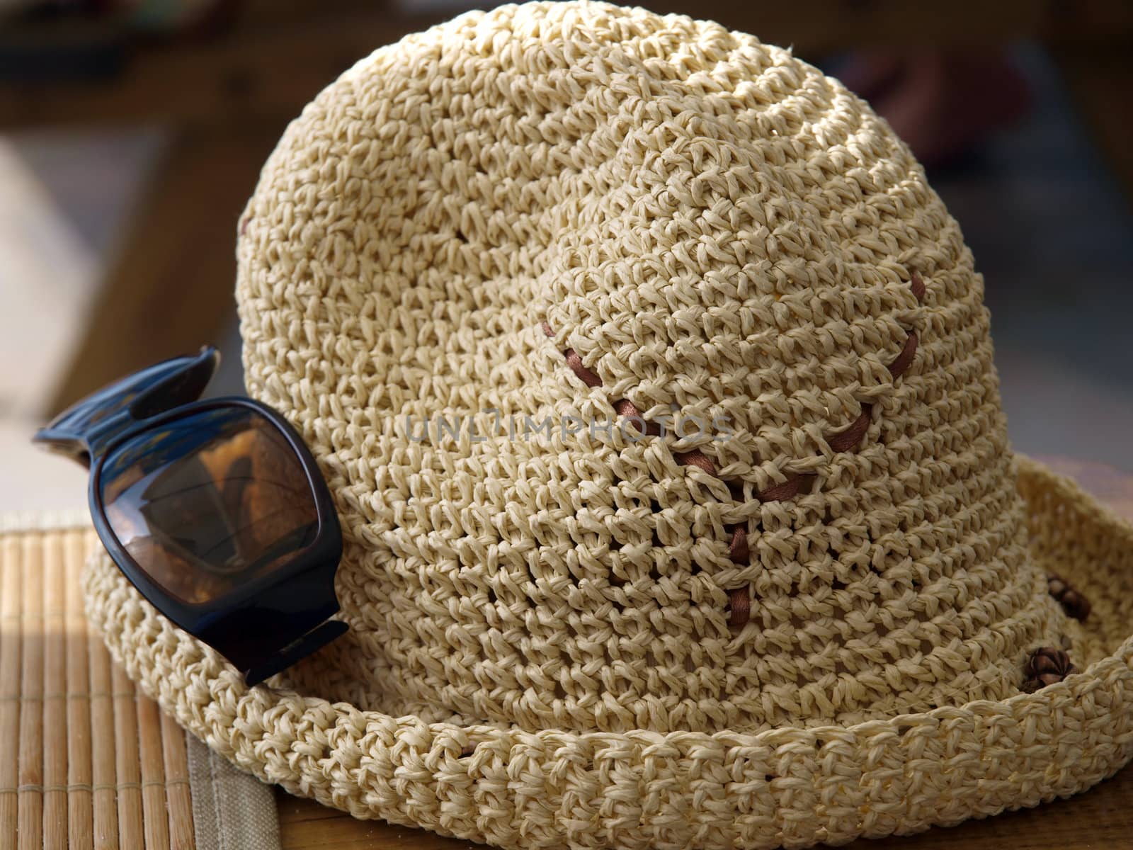 A hat and sunglasses - beach attributes