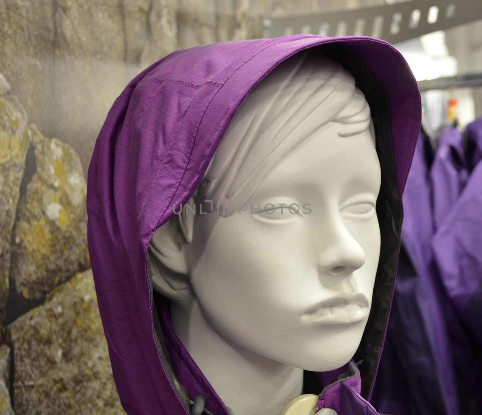 Close up of mannequin head wearing purple hood