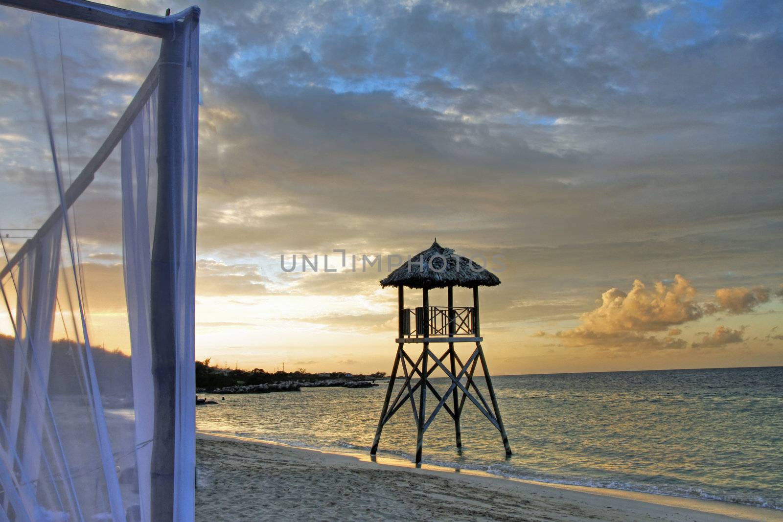 Tropical watchtower overlooking a beach wedding set up