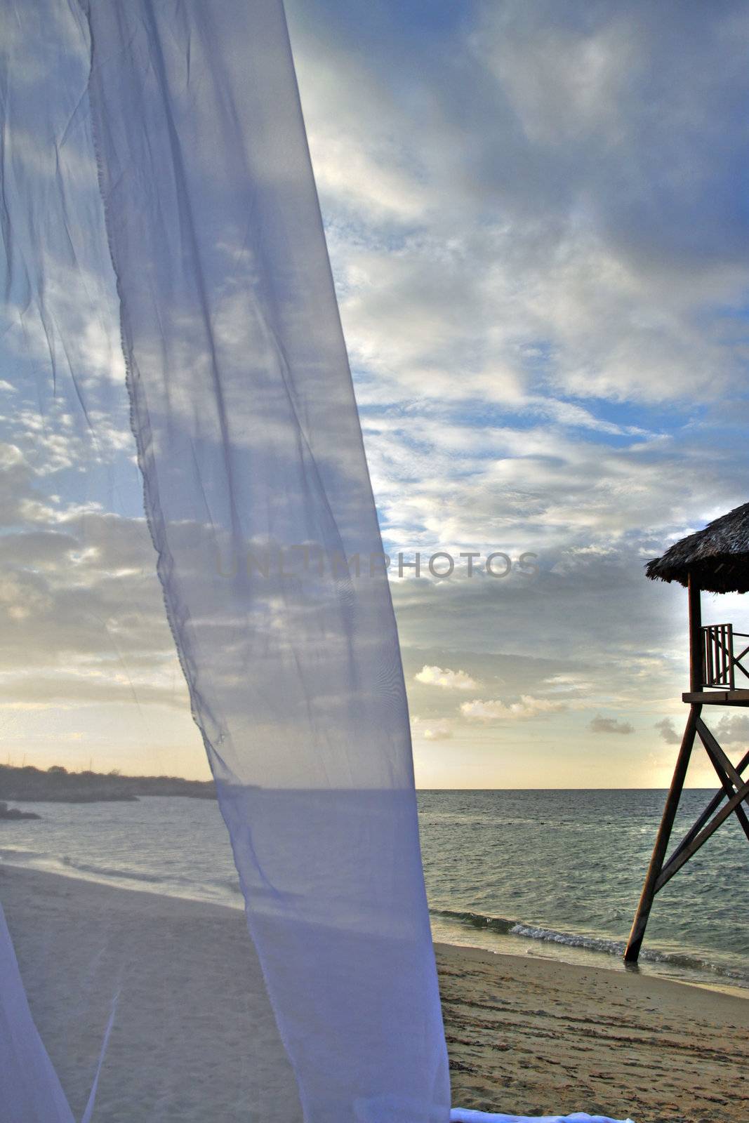 Tropical watchtower overlooking a beach wedding set up