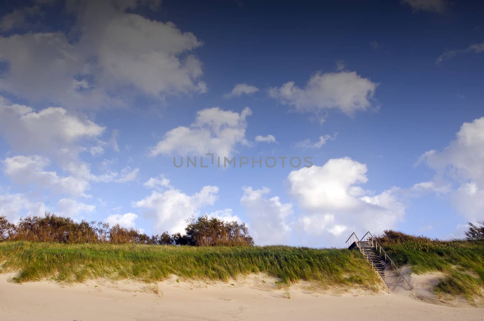 Coast dune and stair leading up cover sea sand. by sauletas