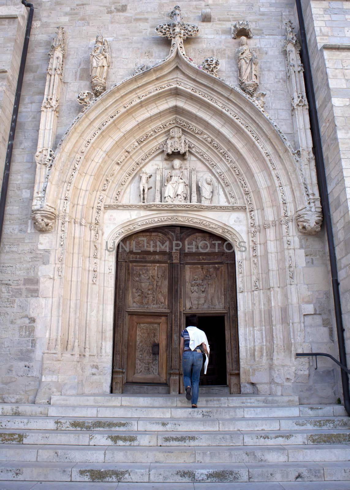 Faithful goes to church. Door of the cathedral, Burgos - Spain