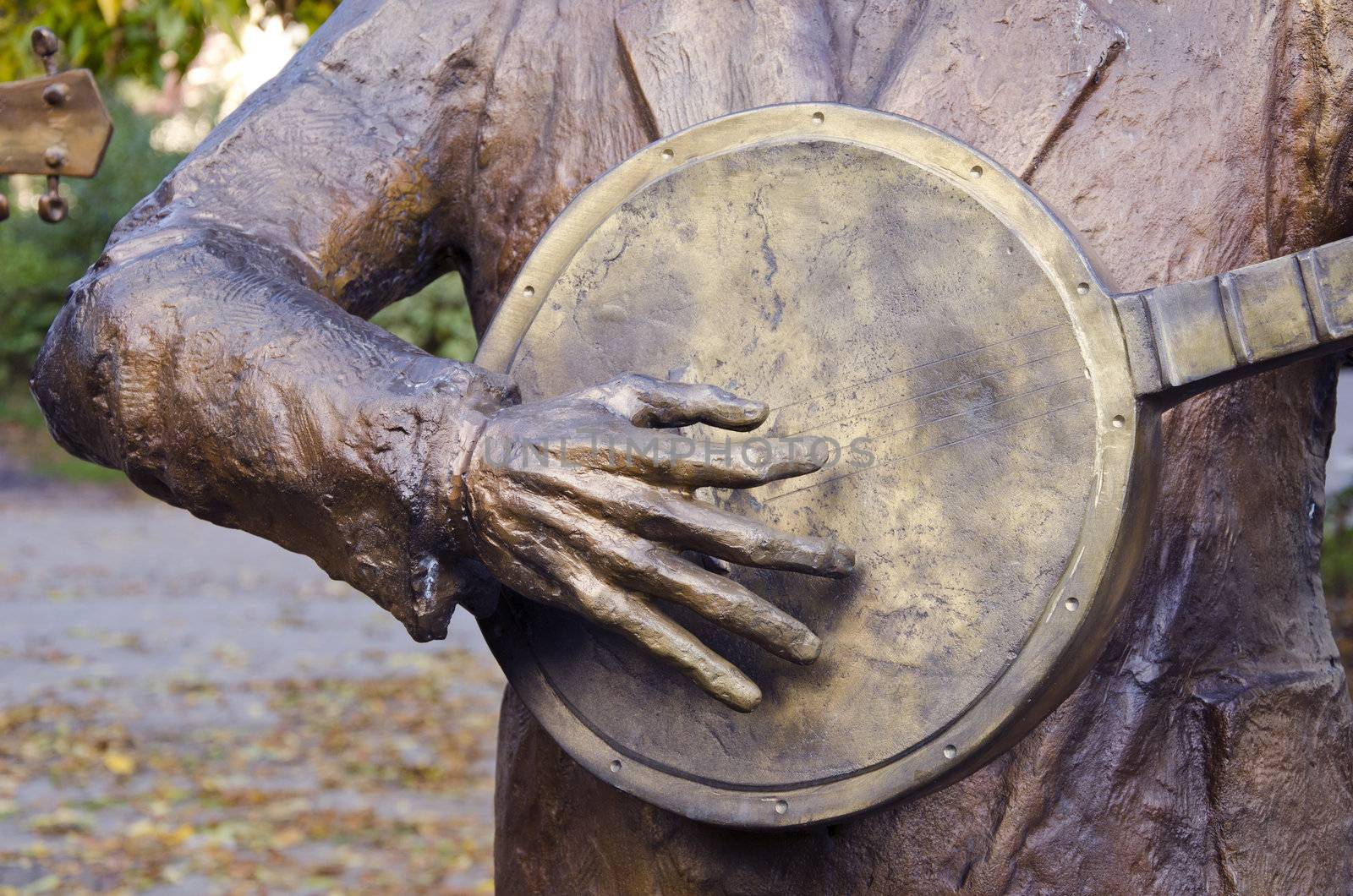 Sculpture plays guitar or balalaika fragment. In memory of famous musician.