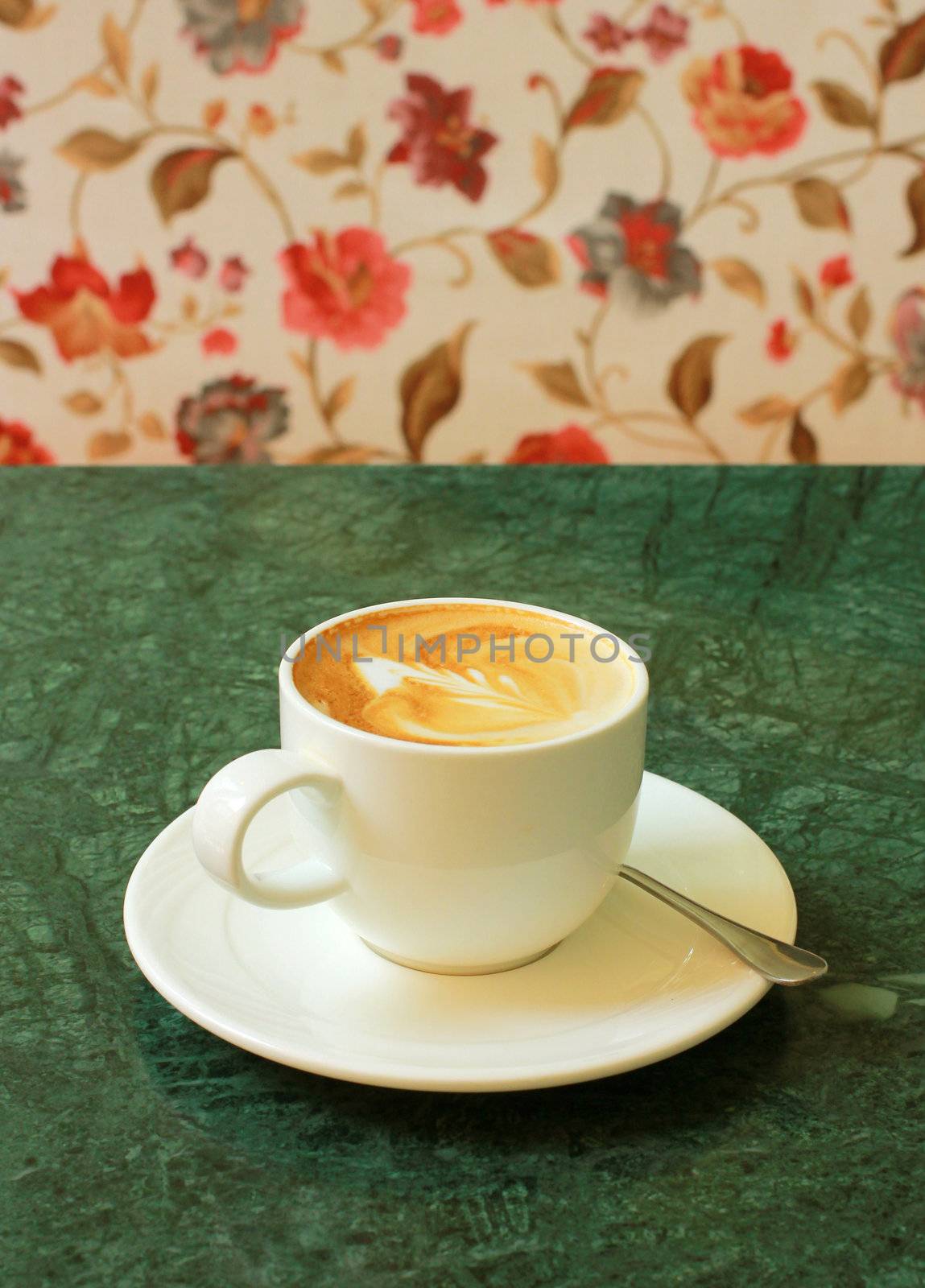 Cappuccino or latte coffee on table with flower chair by nuchylee