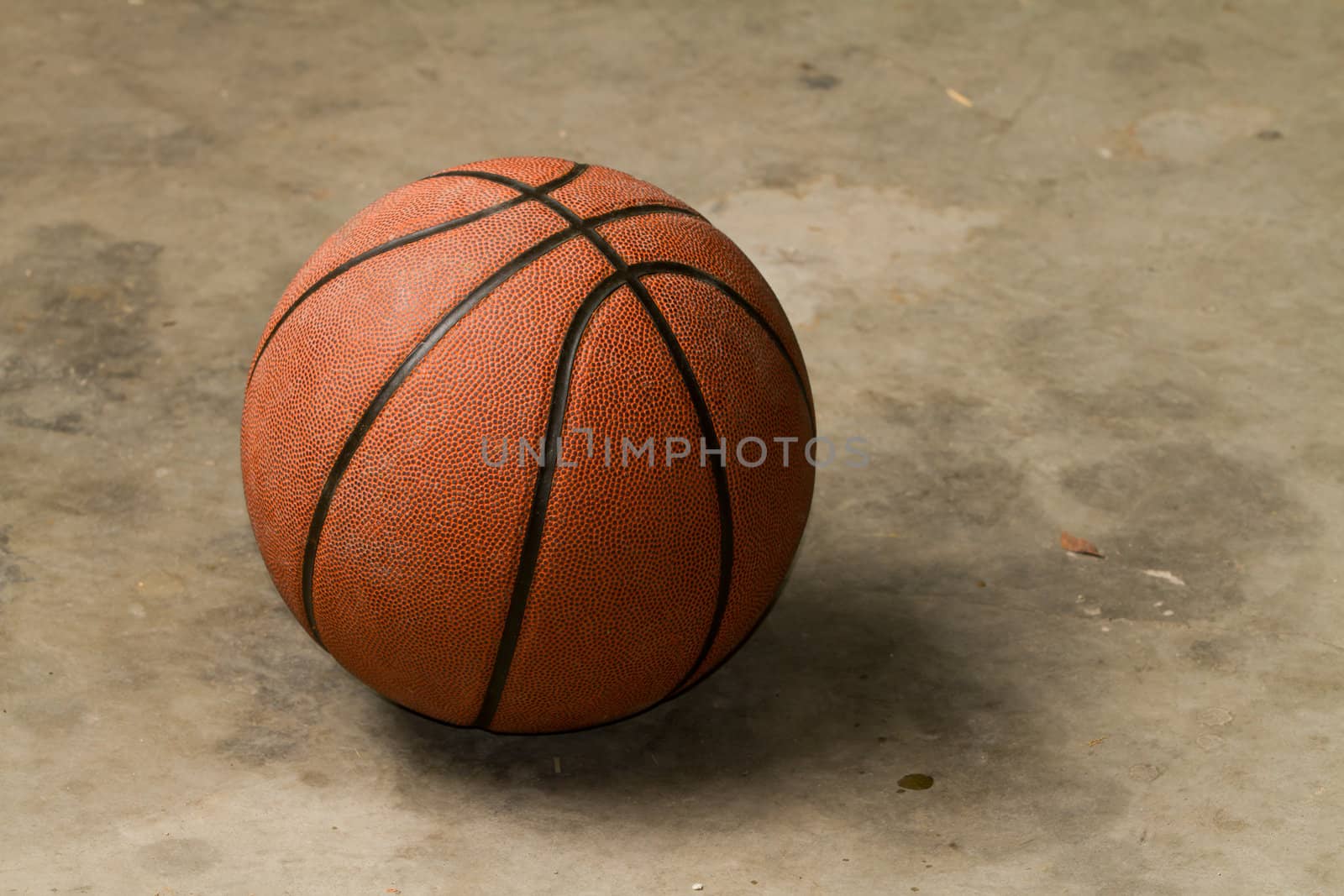 basketball on cement floor by chrisroll