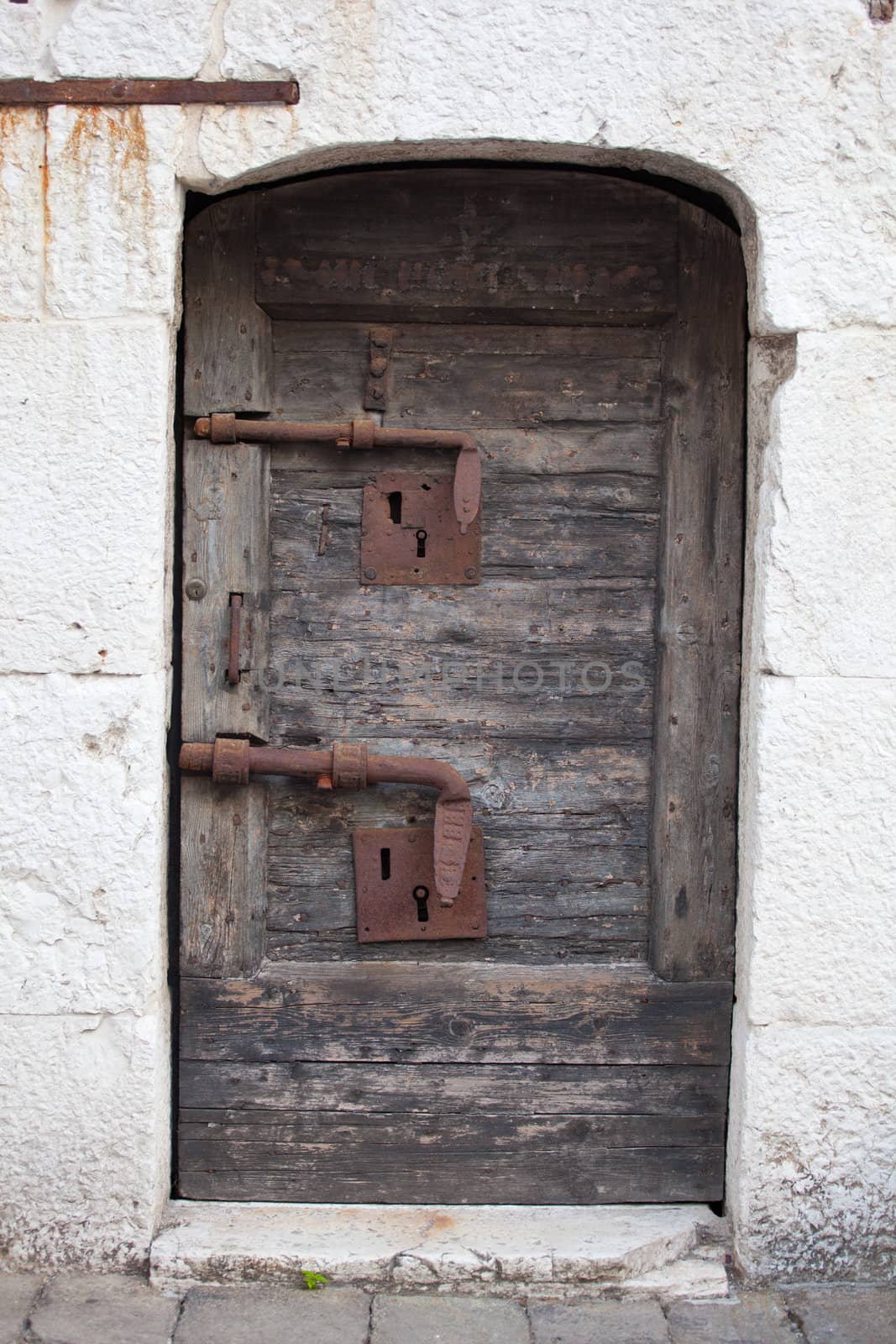 Old wooden door with rusty bolt