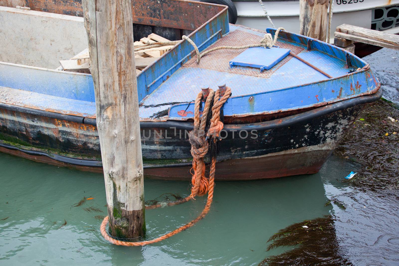 Old boat about to sink in Venice