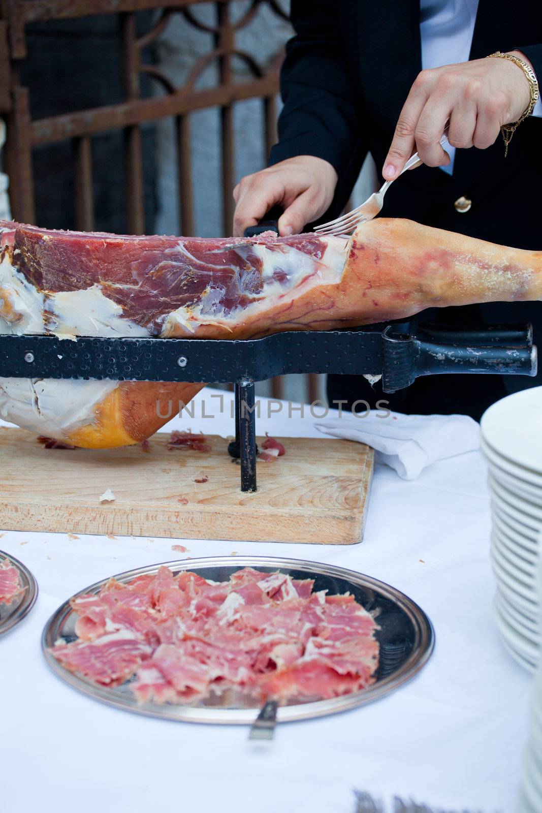 Waiter while slicing jamon, the spanish ham