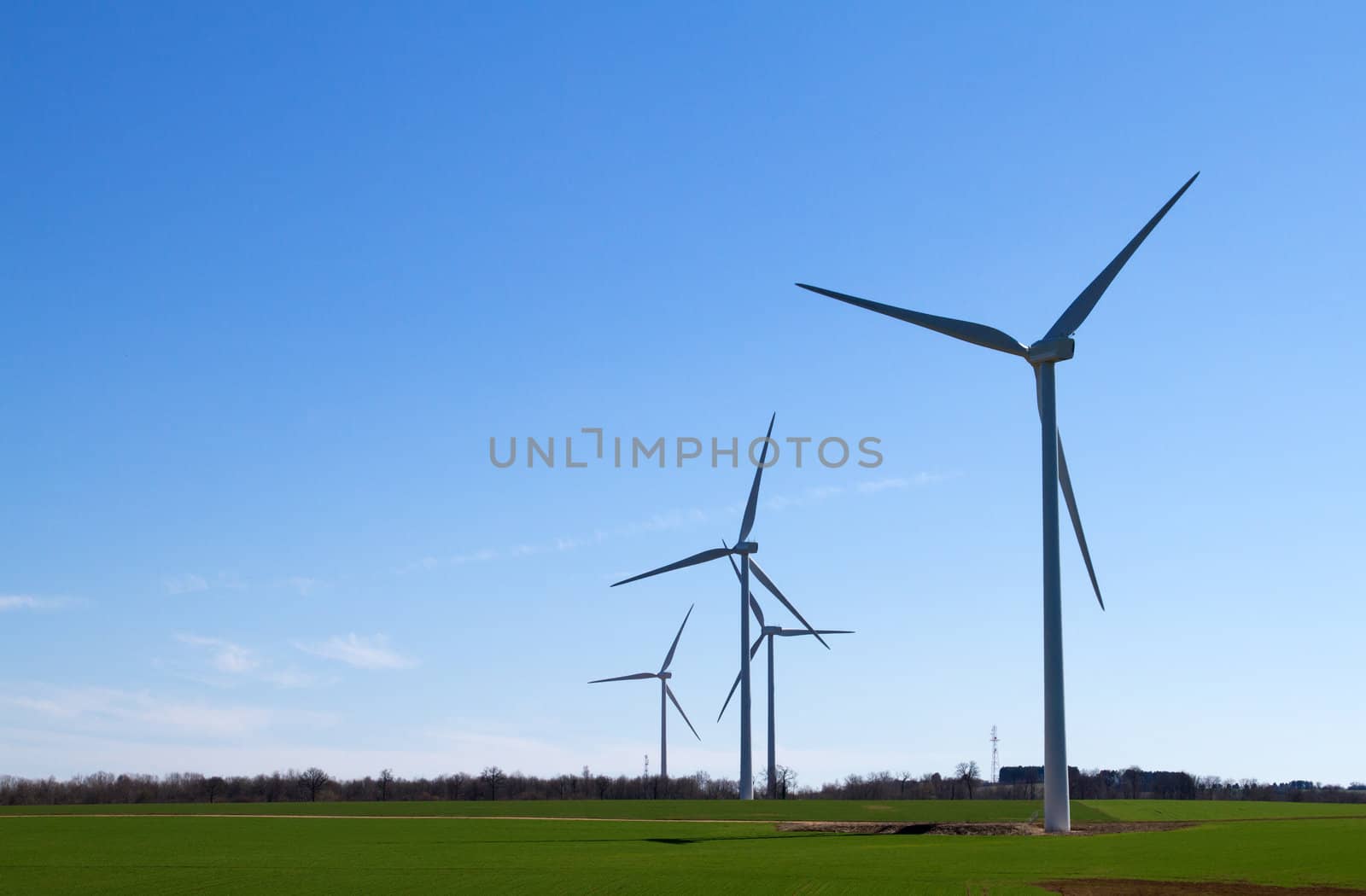 A wind turbine under clear blue sky