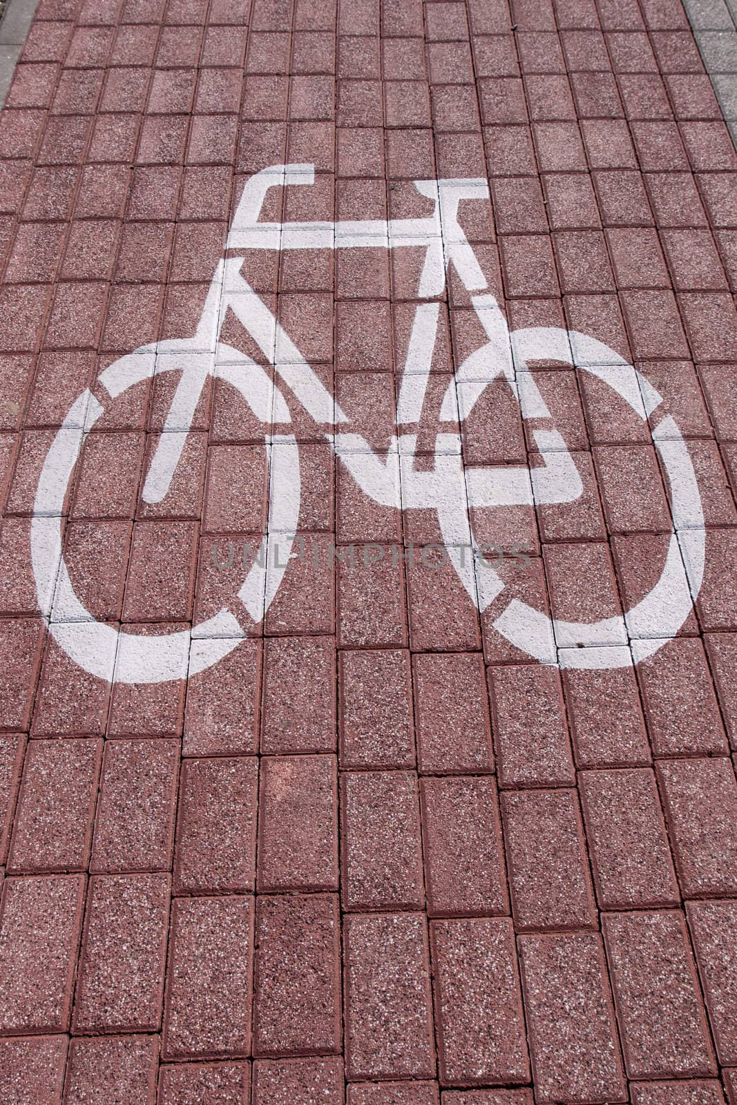 bike sign painted on a brick pavement