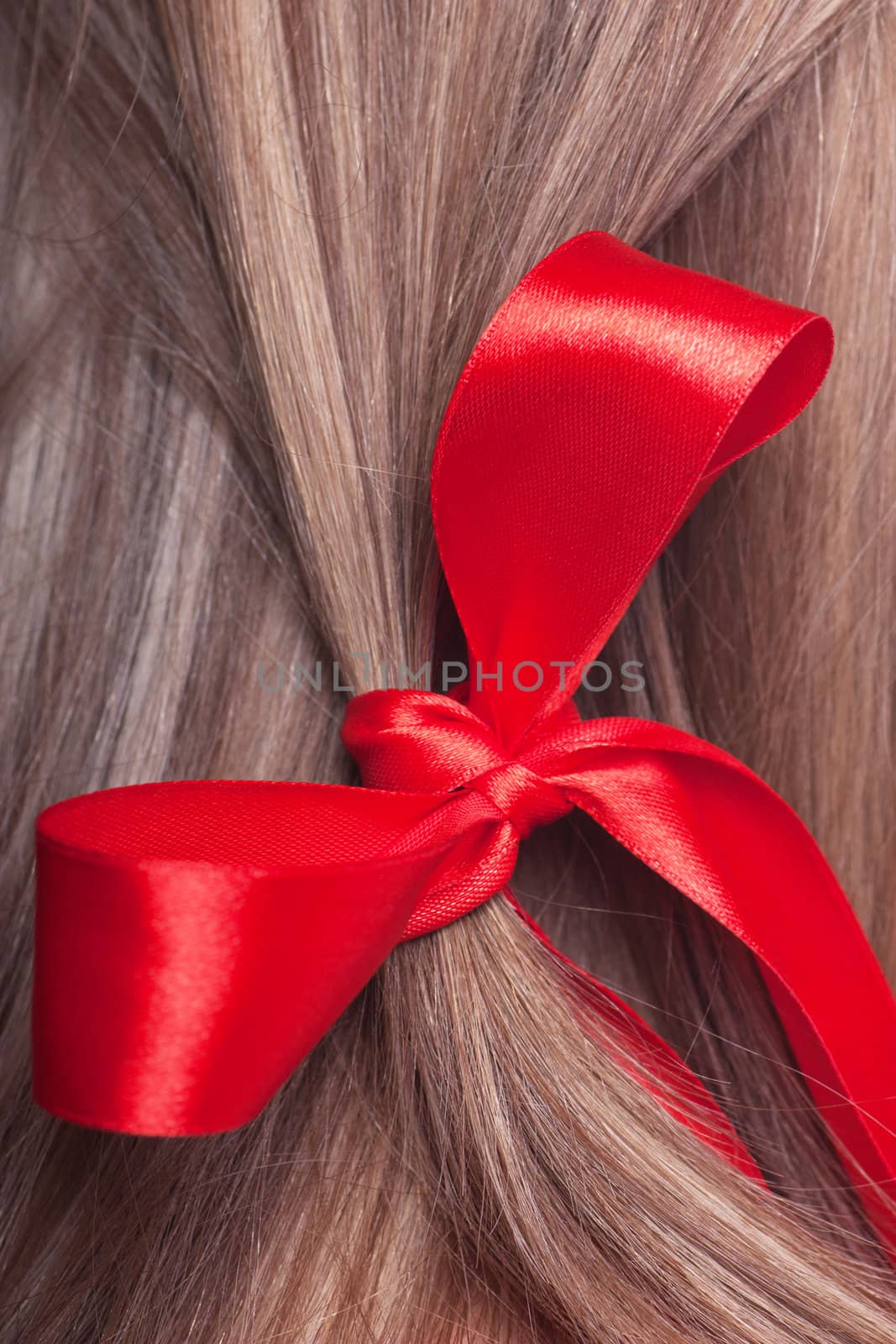 Closeup view of red bow in a womans hair