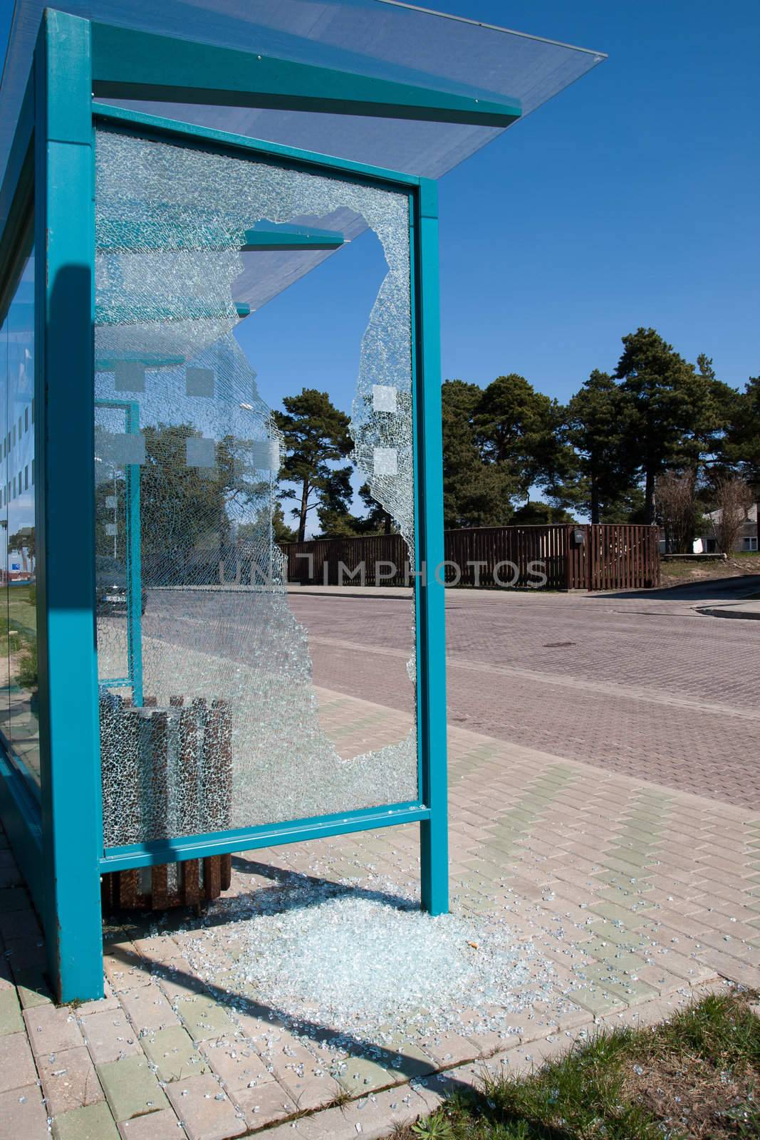 Damaged glass at a bus stop shed