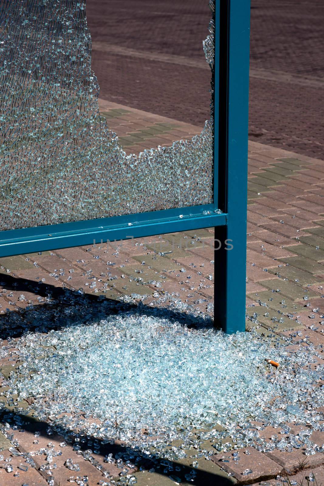 Damaged glass at a bus stop shed