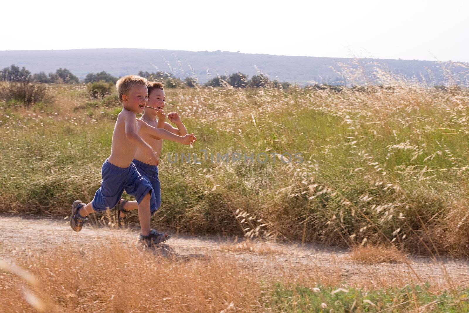 Young children running in the nature by chrisroll