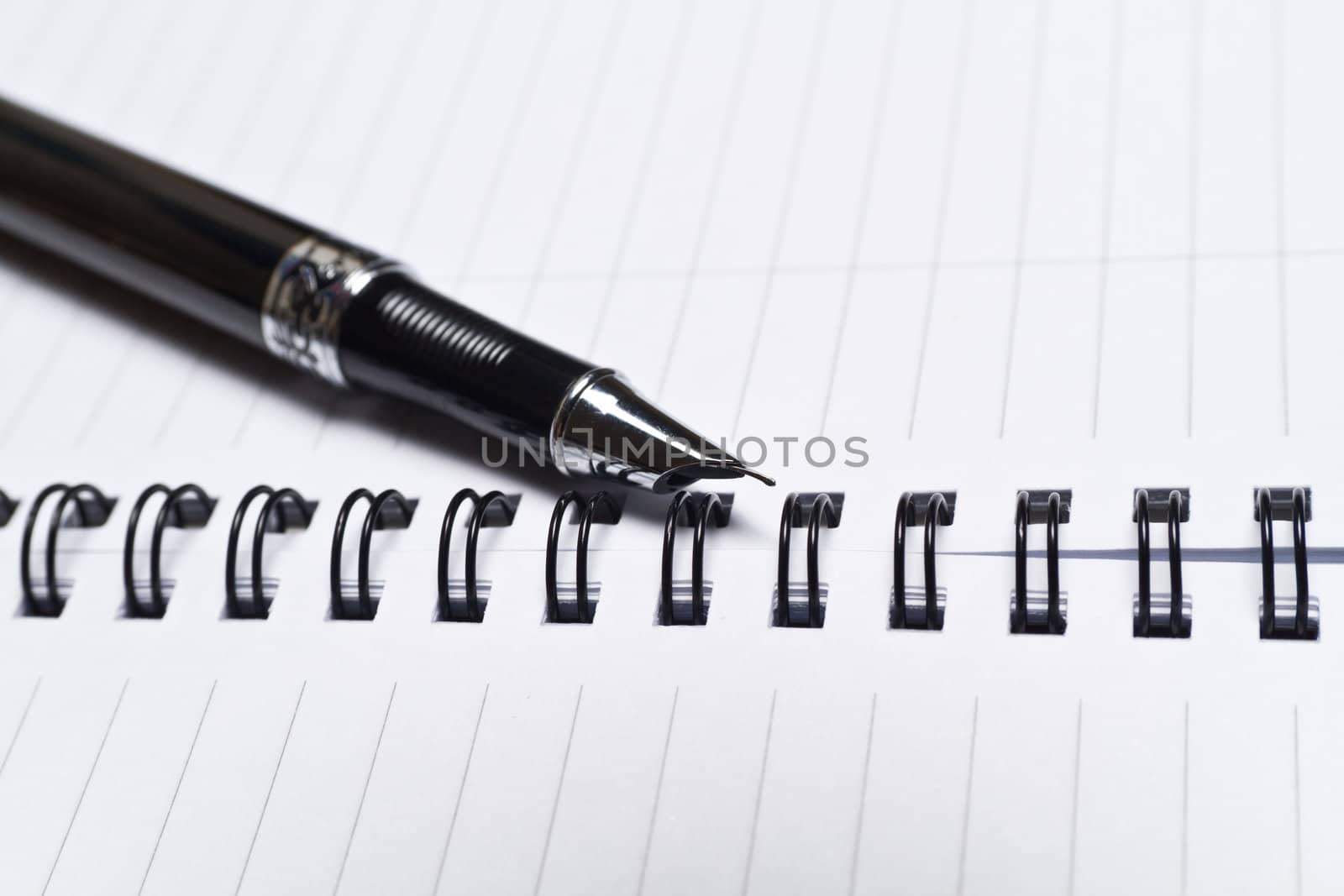 a close up view of an opened note book and a pen