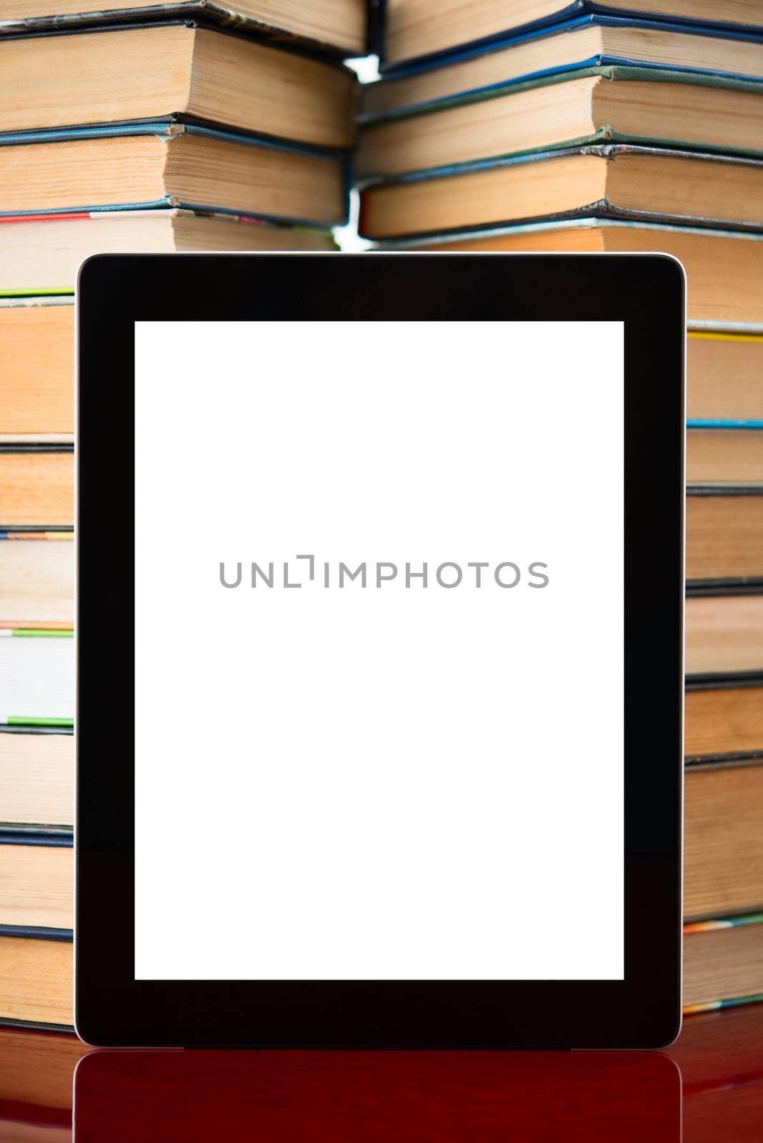 tablet pc with blank screen on a book background