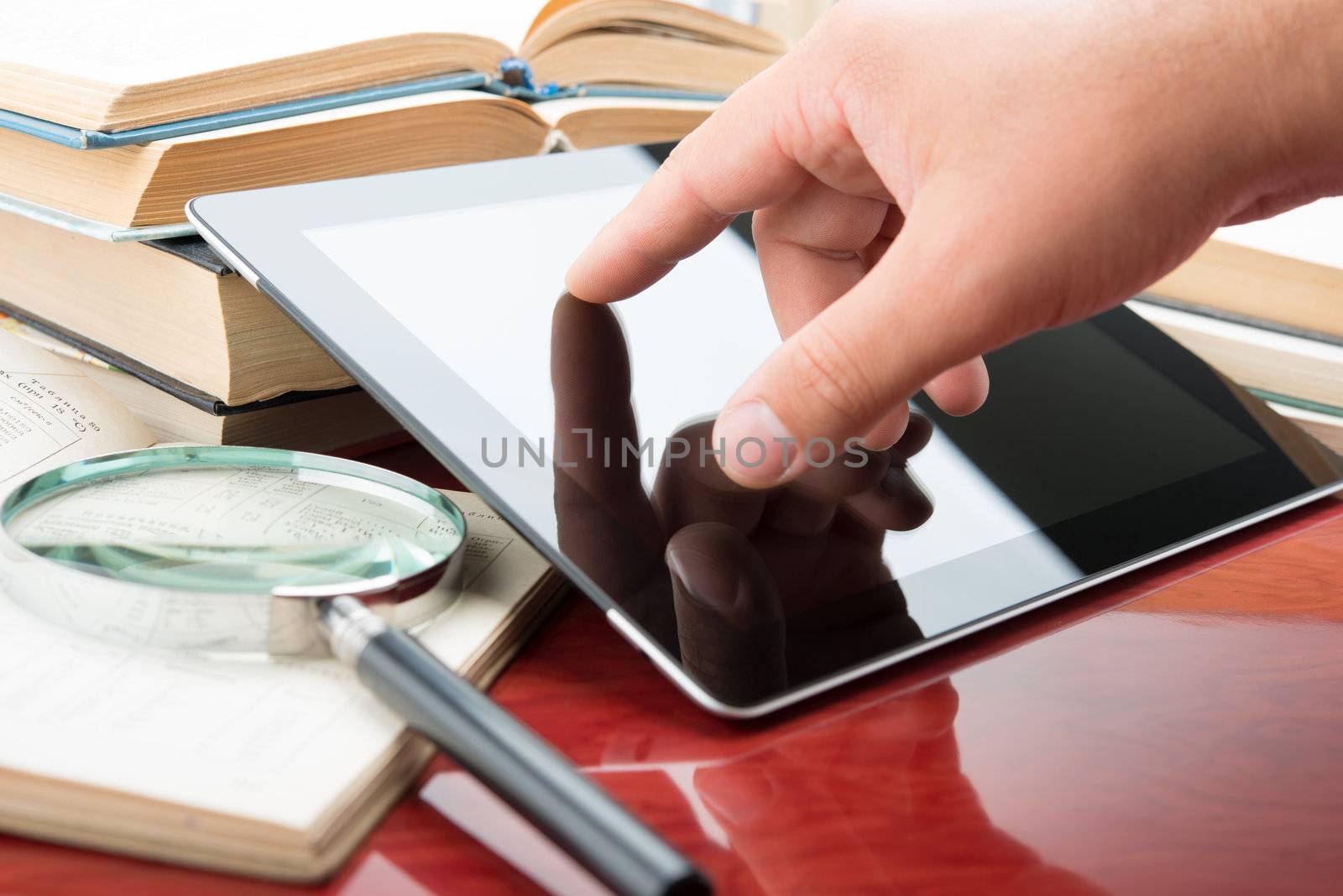 Hand touching a touchscreen of tablet pc