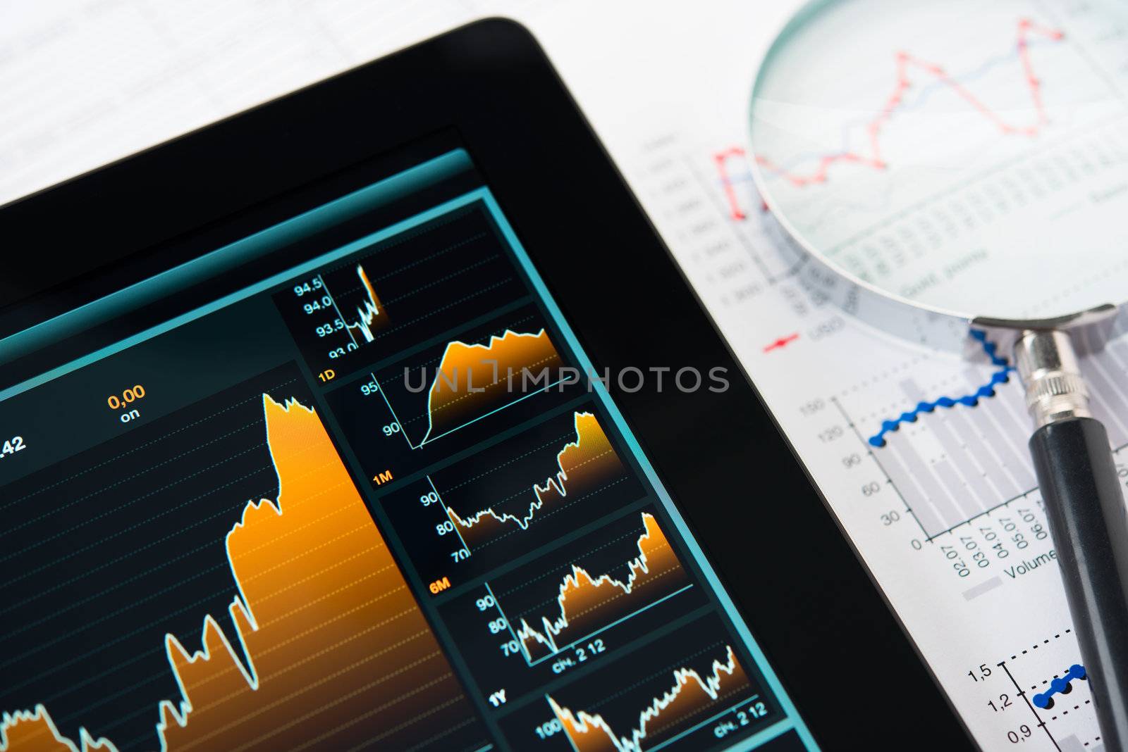 Businessman hand touching screen of tablet pc with market graph