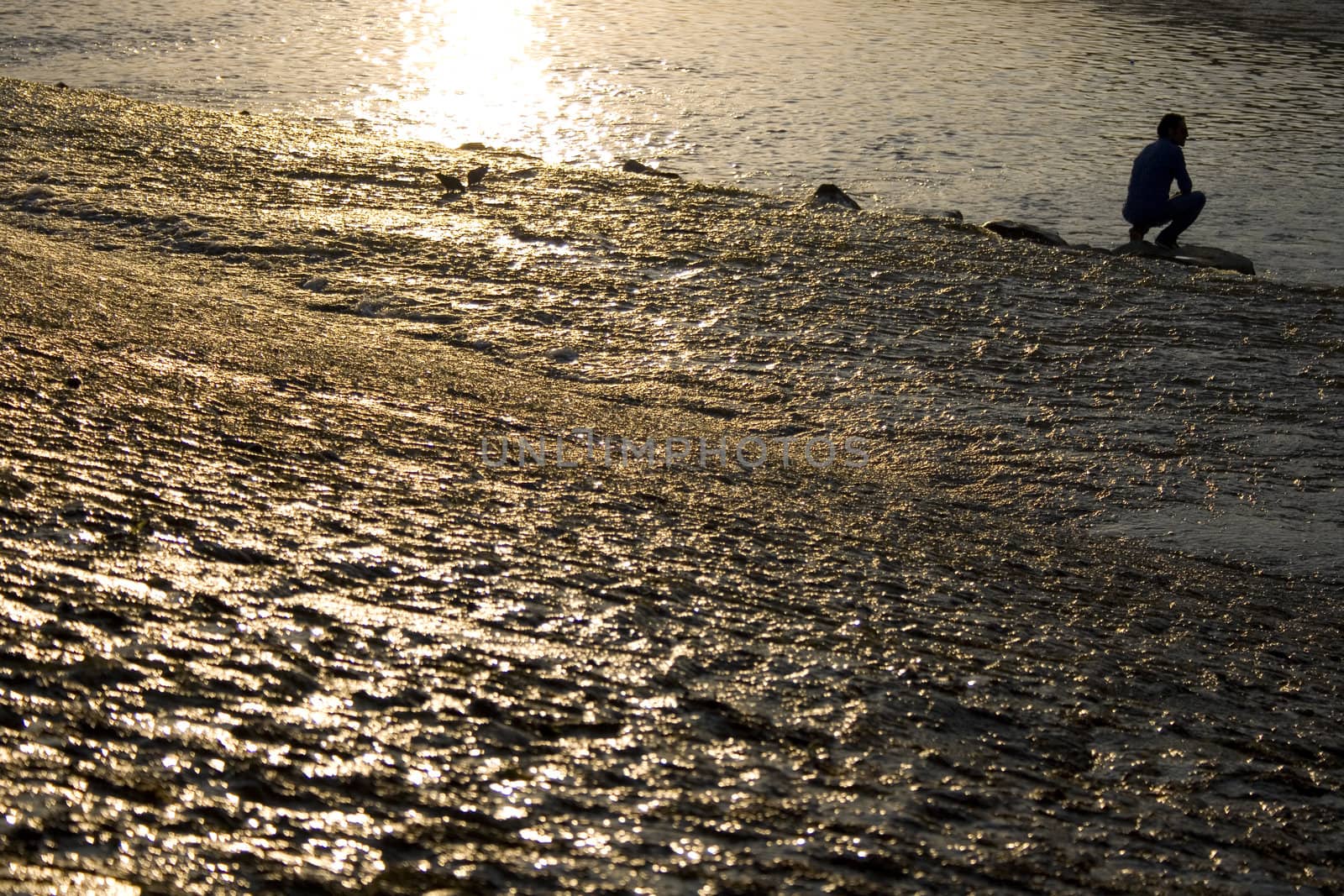 A man on the water, Arno river at sunset, Florence - Italy