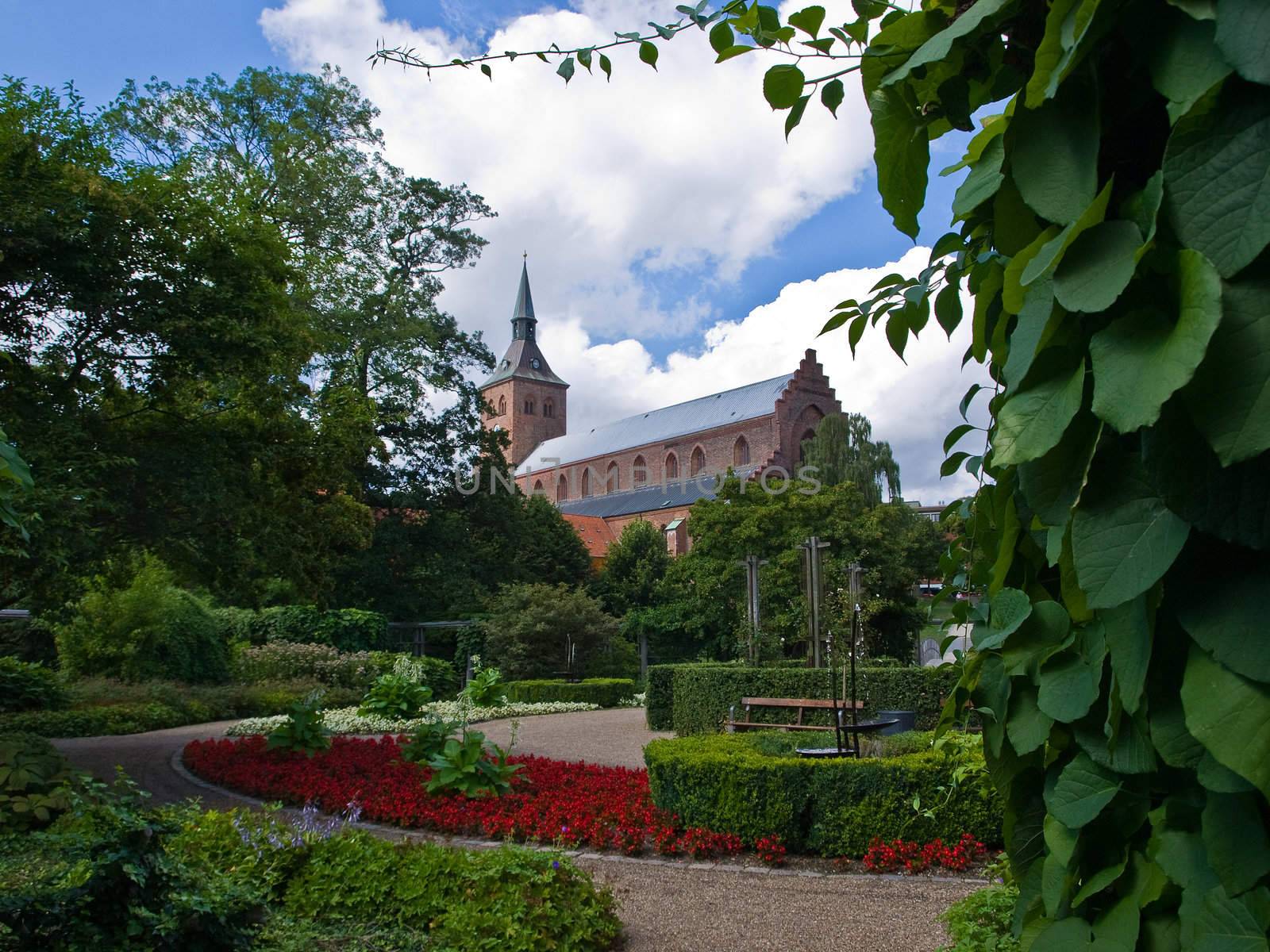 Odense the third largest city in Denmark as viewed from a green park garden