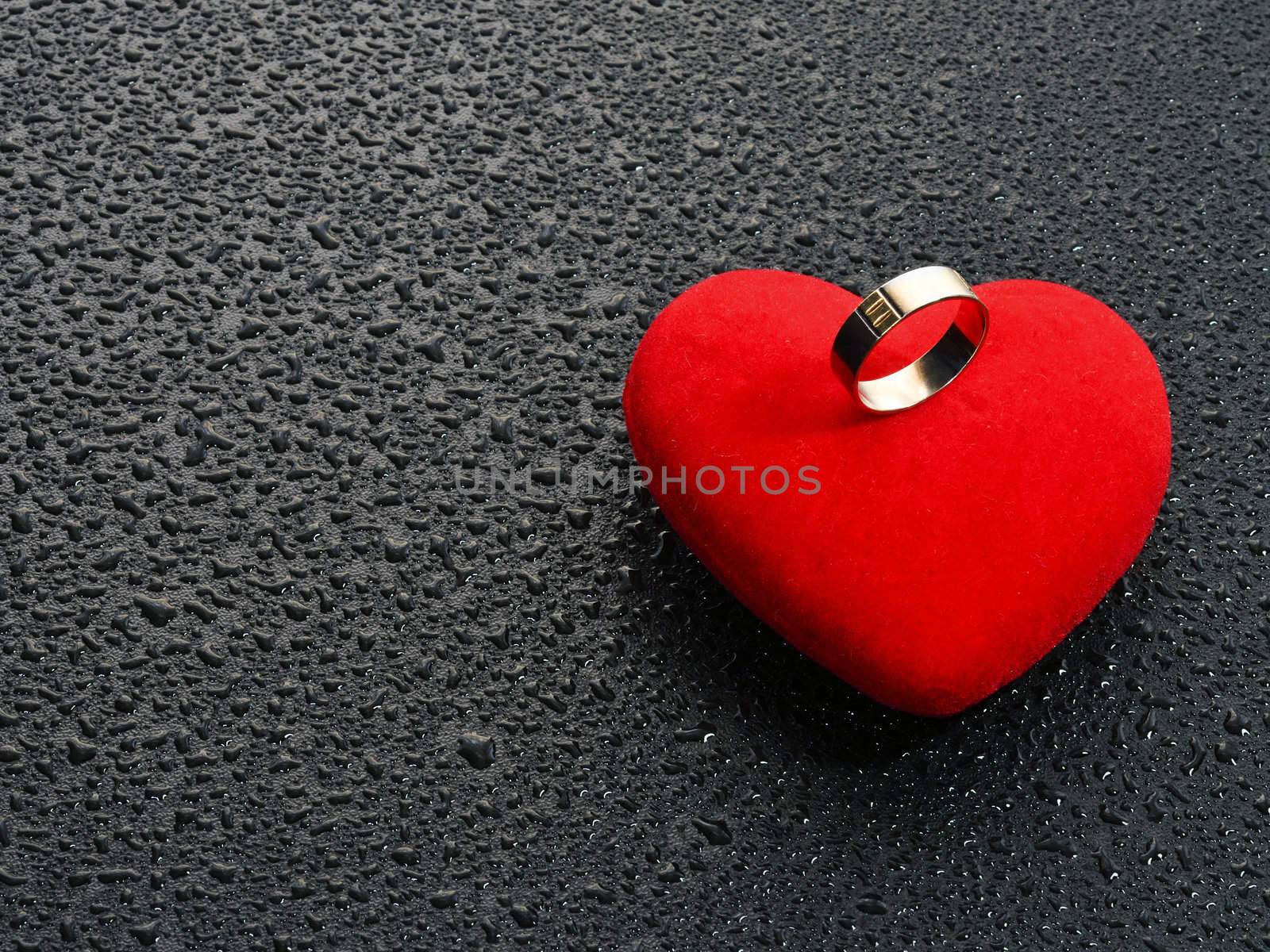 Wedding ring that sits on a red heart