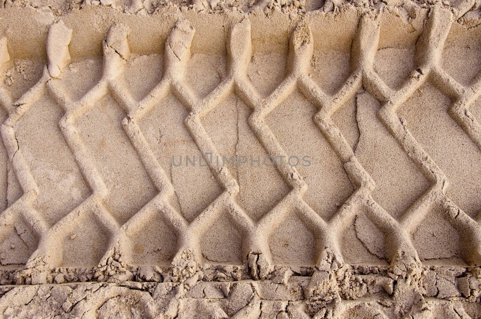 industrial car tyre traces on sand background