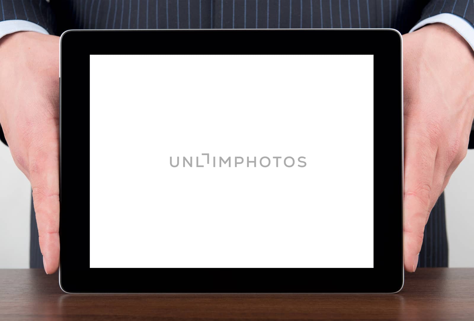 Man holding blank digital tablet on a desk with clipping path