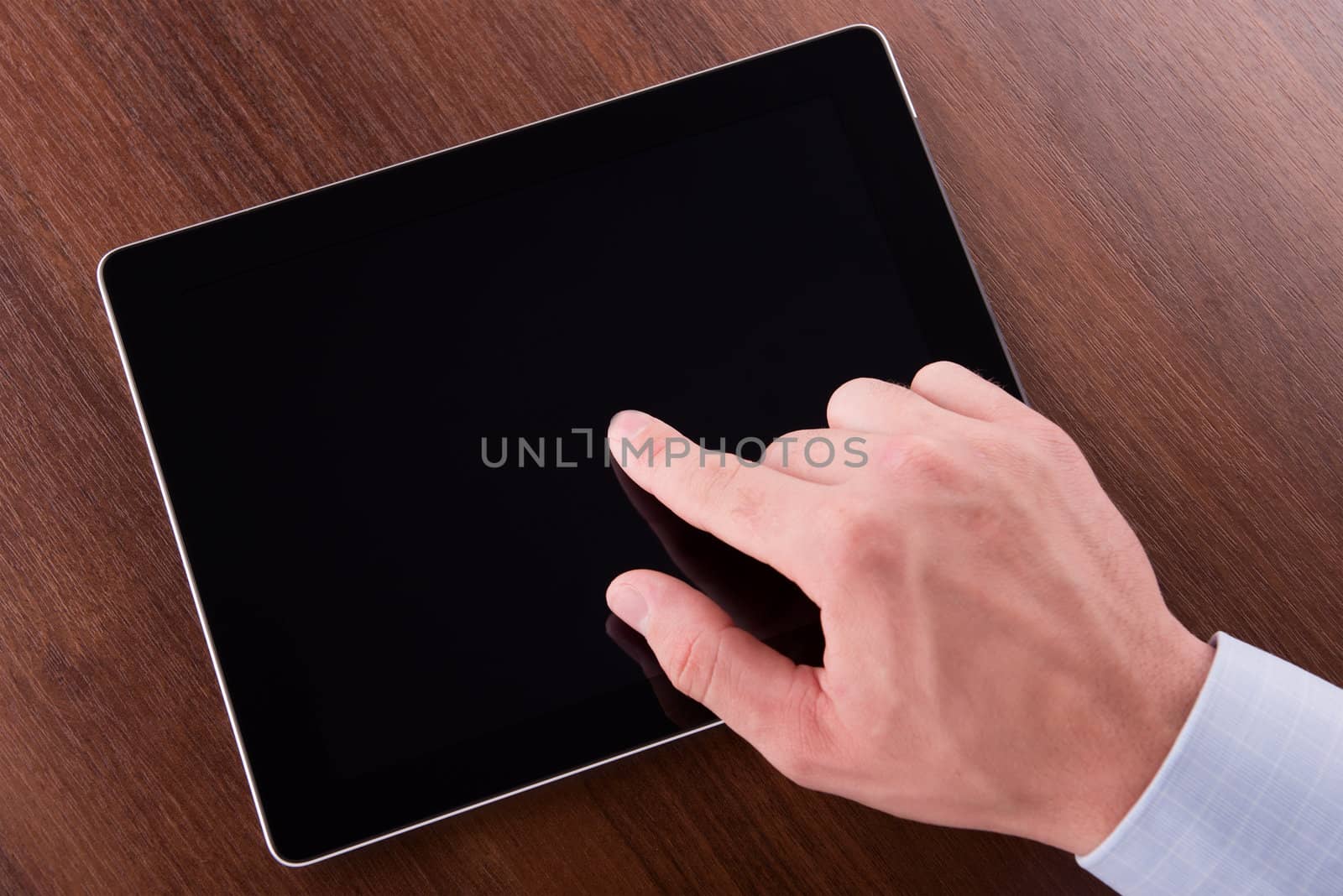 hand on a touch screen of tablet pc by Emevil