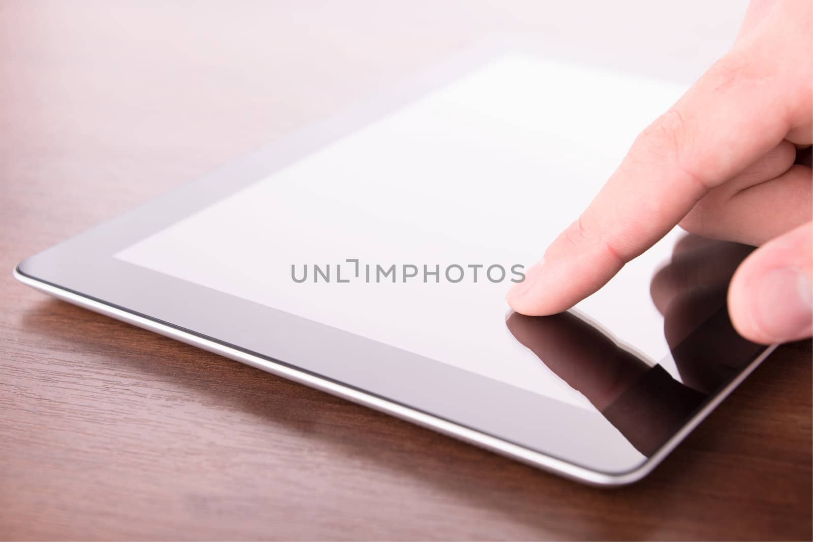 hand touching screen on modern digital tablet pc by Emevil