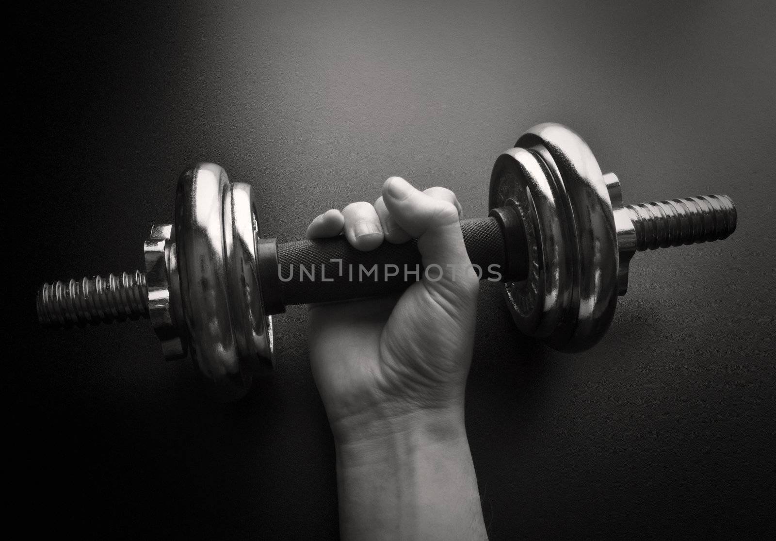 Young man working out with a  dumbbell-NOTE:Grain and contrast was added