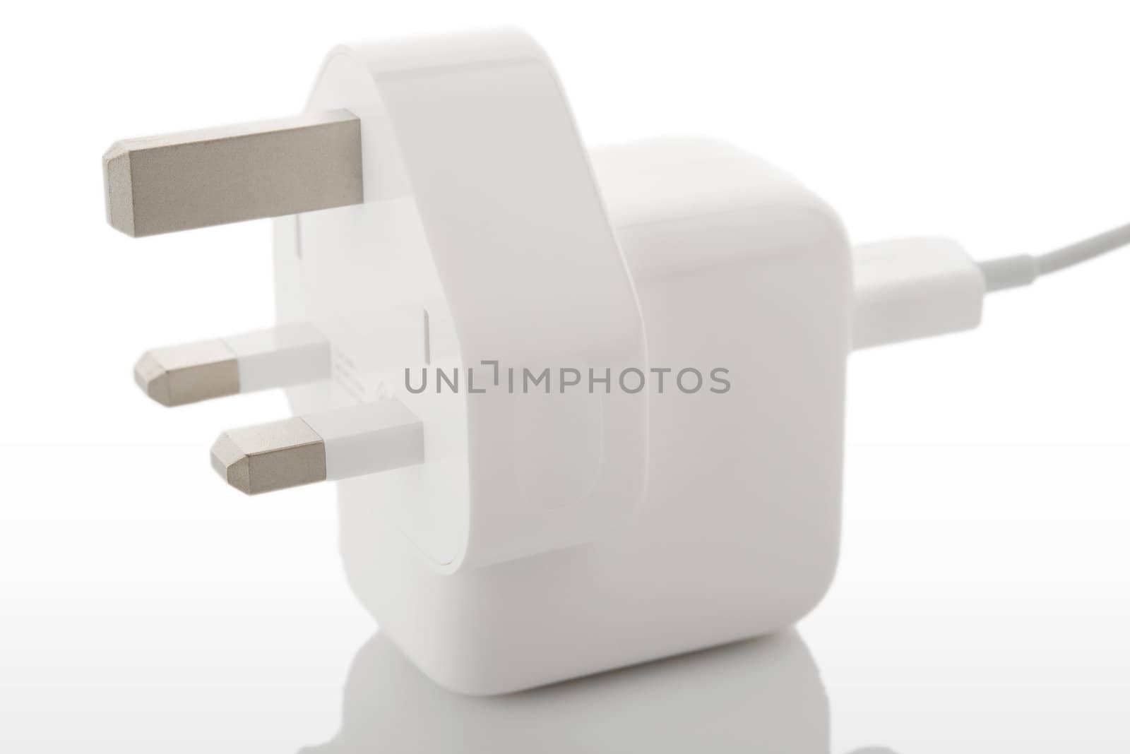 White electric plug on a hite background with reflection