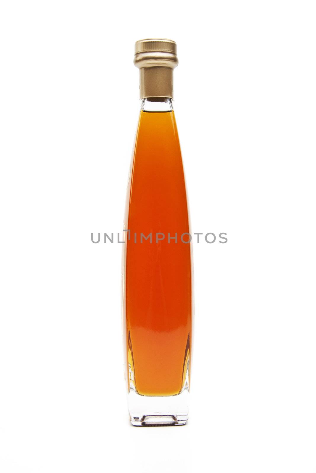 Alcohol cognac in a closed bottle on white background