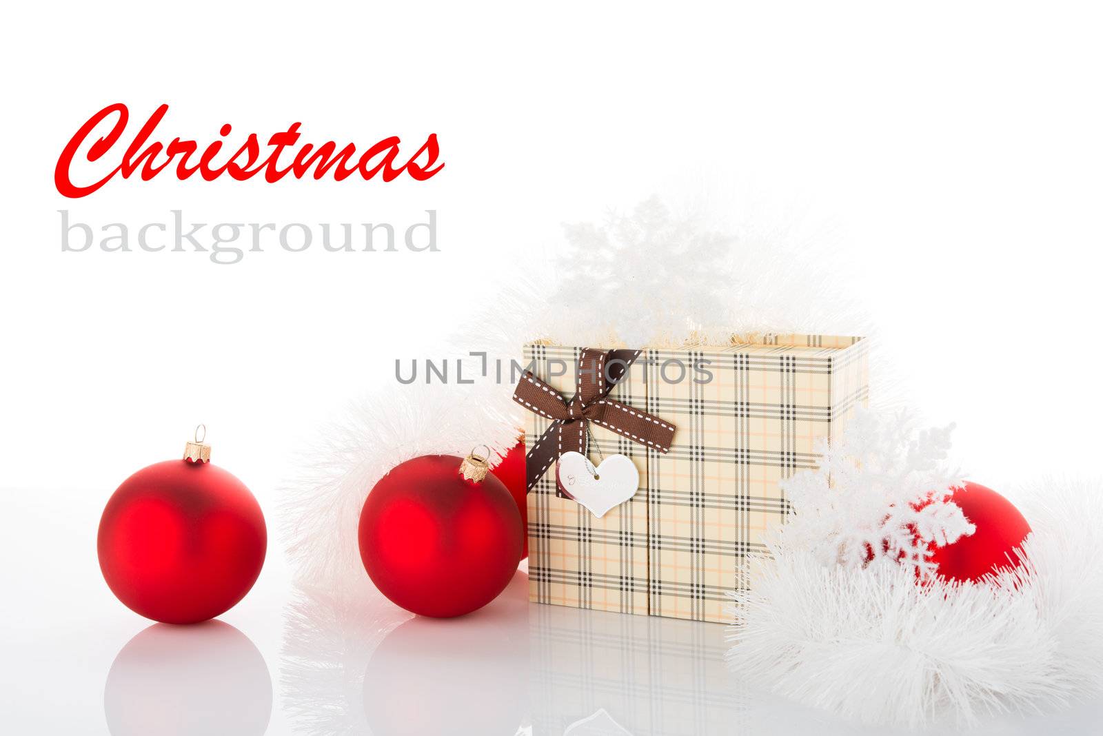 Gift box and Christmas tree decorations on white background