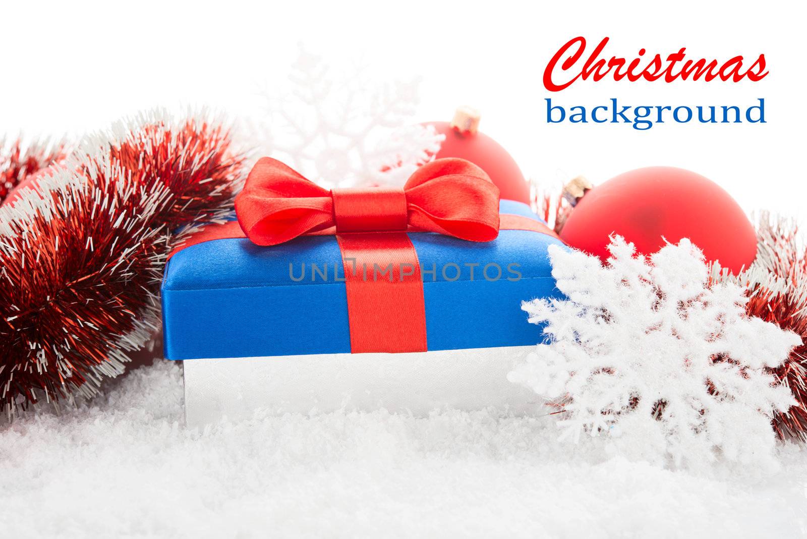 Gift box and Christmas tree decorations on a snow.