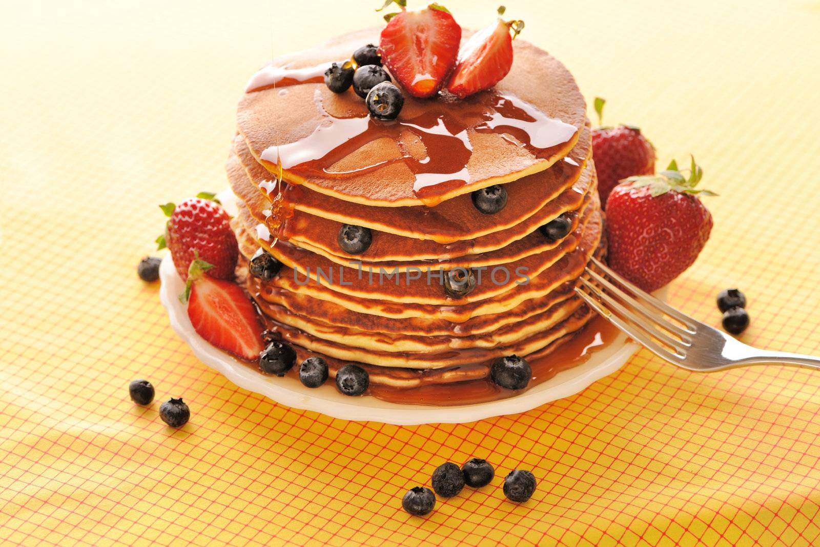 Delicious freshly prepared pancakes with strawberry and blueberries