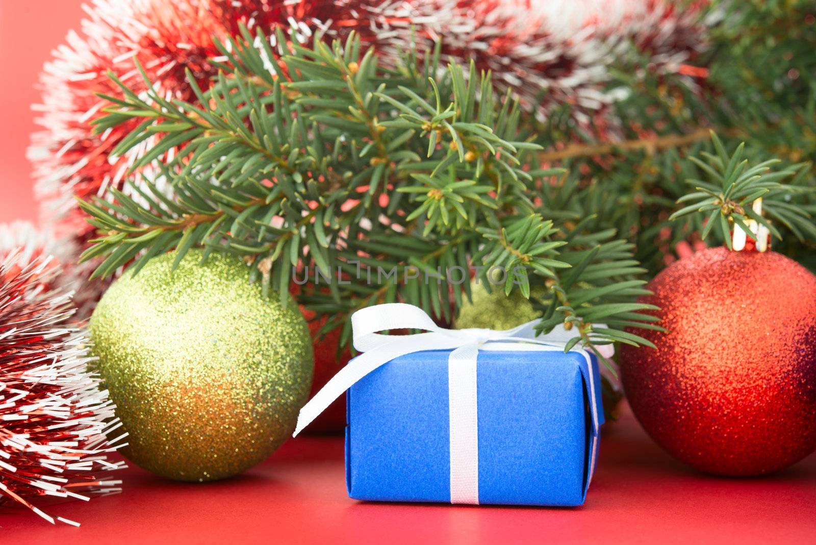 Christmas tree and decorations on red background.