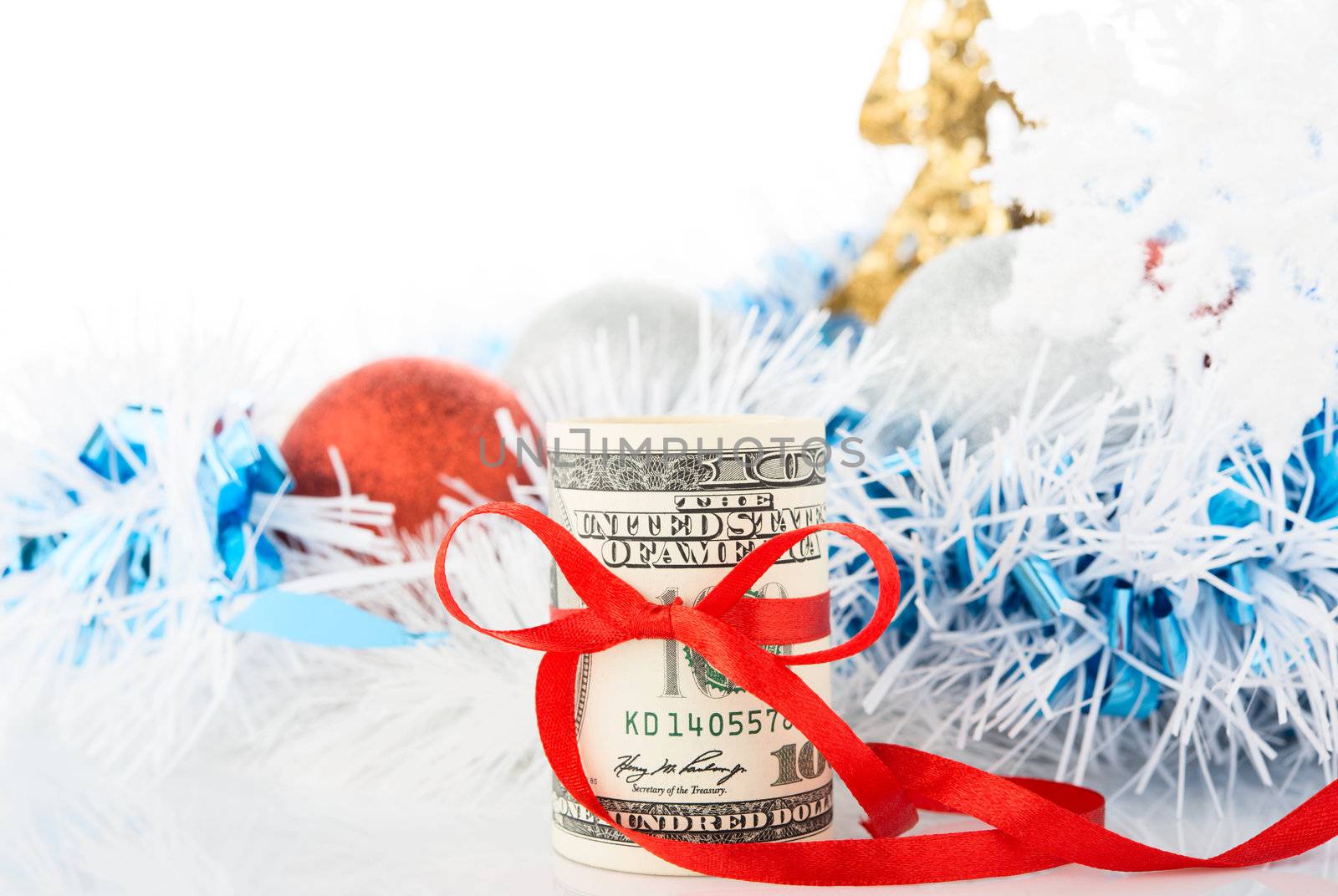 Money and Christmas decorations on white background.