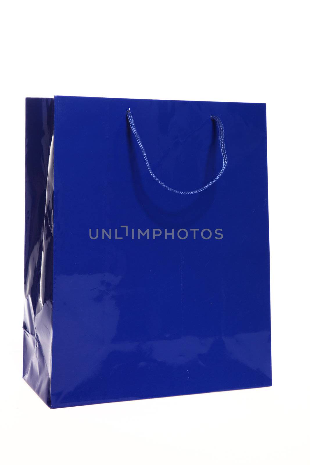 Blue paper shopping or carrier bag for packaging gifts or as a recyclable container for purchases on a shopping spree isolated on white