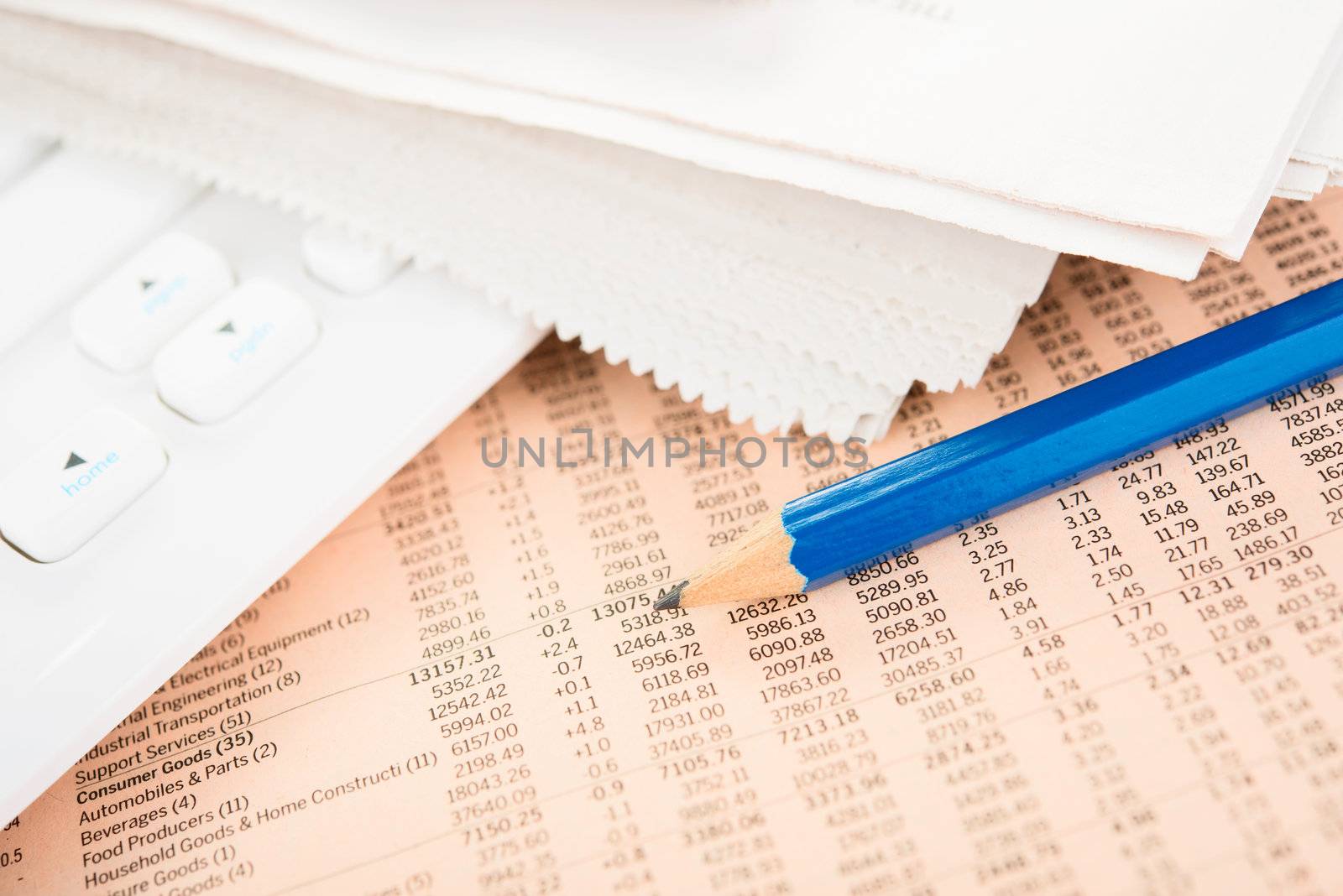 Business data in Newspaper with pencil and keyboard
